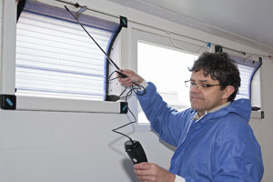 Tim Miller, ARM s environment specialist, checks an air inlet with an anemometer, as part of the new annual  MOT  service for ARM piggeries.