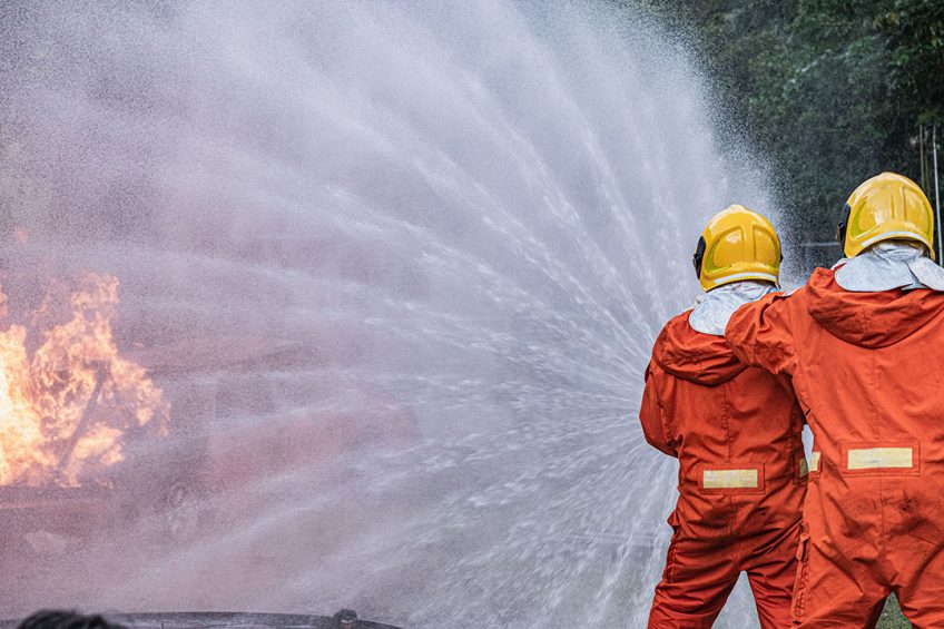 Firefighters trying to put out a real fire.