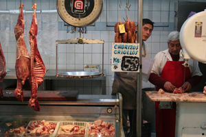 An Argentinian butcher, selling pork, beef and poultry, is waiting for customers.