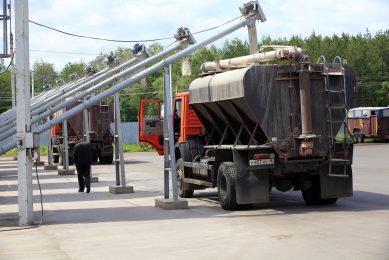 A pig farm is being re-stocked with feed.