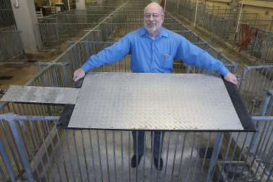 Robert Stwalley, assistant professor at Purdue University, shows a cooling pad designed to keep sows more comfortable during farrowing. Photo: Purdue Agricultural Communication photo/Tom Campbell