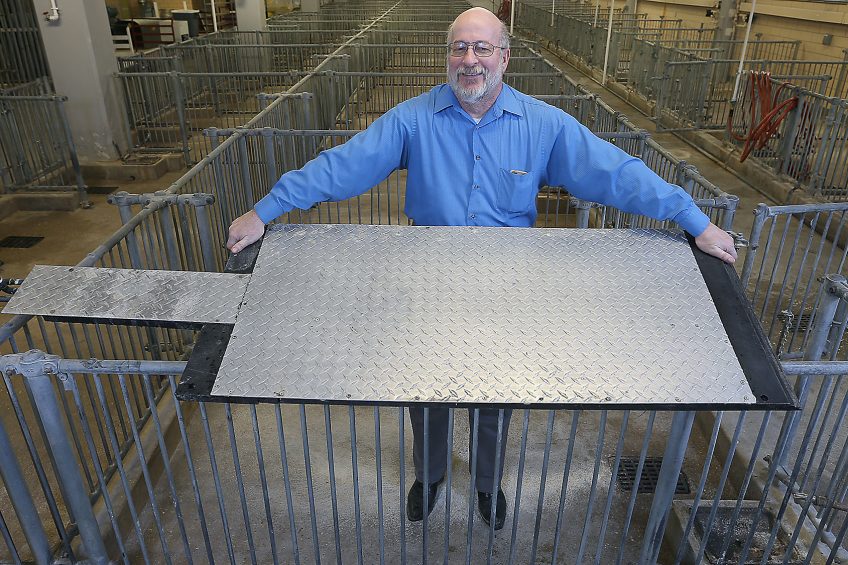 Robert Stwalley, assistant professor at Purdue University, shows a cooling pad designed to keep sows more comfortable during farrowing. Photo: Purdue Agricultural Communication photo/Tom Campbell