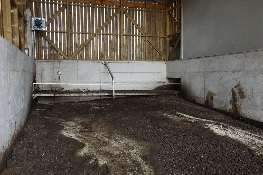 The thick fraction is being collected in a shed at the far end of the pig house.