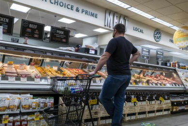 Will I go for pork today? A man contemplating his choices at a supermarket in Washington state, USA. Photo: Dreamstime
